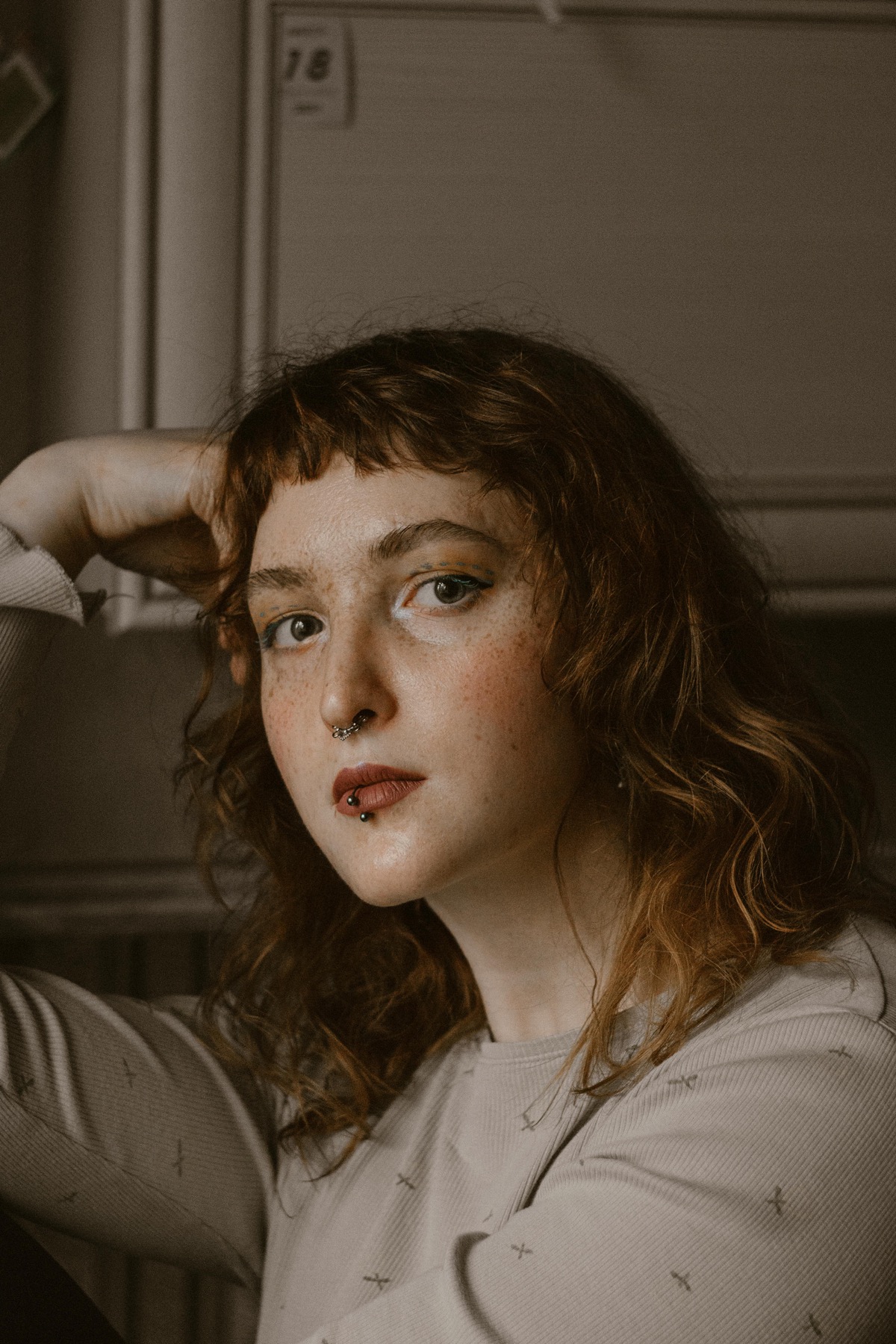 Portrait with a septum ring and centered labret piercing